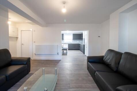 A spacious and modern living room featuring com...