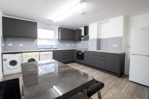 A modern kitchen featuring sleek gray cabinetry...