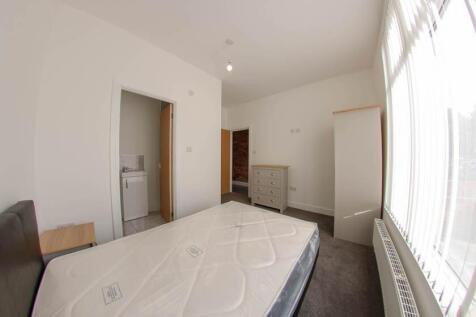Bright and spacious bedroom with a large window...