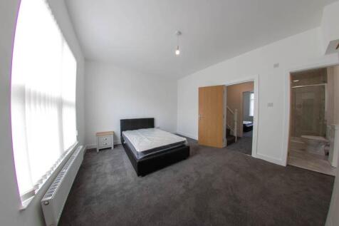 Bright and modern bedroom with large windows al...