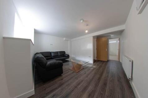 A spacious and modern living room featuring a l...