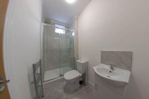 A modern and clean bathroom featuring a toilet ...