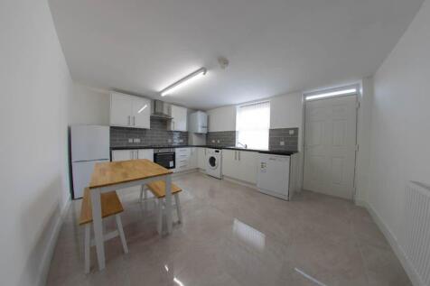 A bright and modern kitchen featuring ample whi...