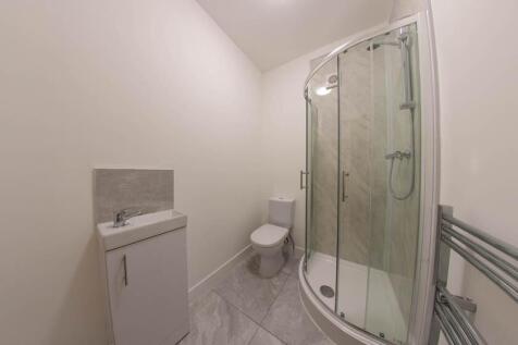 A clean, modern bathroom with a spacious shower...