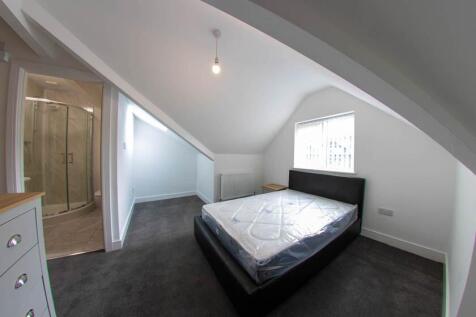 A bright and well-maintained bedroom with a lar...