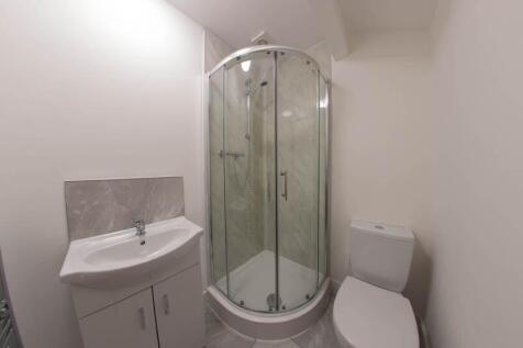 A clean and modern bathroom featuring a curved ...