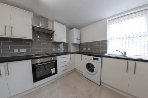 A bright and clean kitchen area featuring moder...