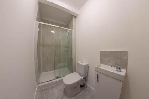 A clean and modern bathroom with a spacious sho...