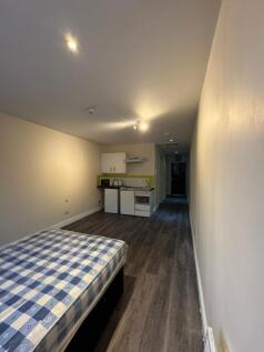 A spacious living area featuring a comfortable ...