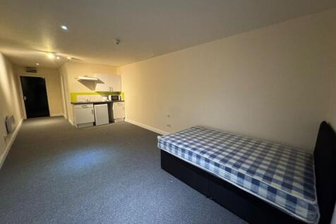 A compact studio apartment featuring a single b...