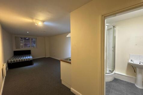 A clean, functional bathroom with a shower, sin...