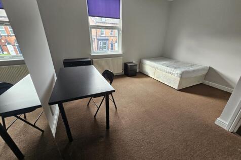 A bright and tidy bedroom featuring a single be...