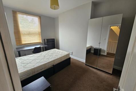 A bright and well-maintained master bedroom fea...