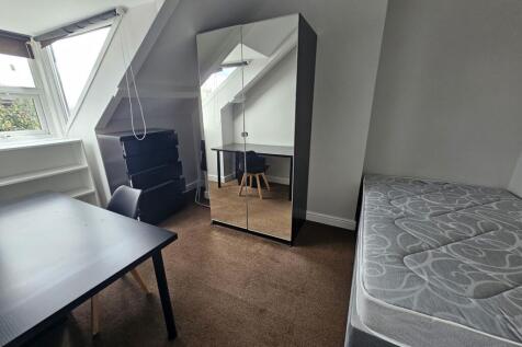 A cozy and well-maintained bedroom featuring a ...