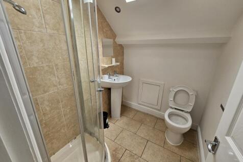 A clean and functional bathroom with a shower e...