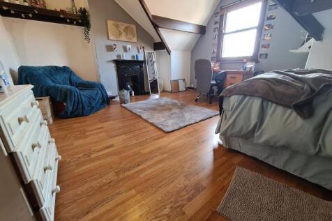 A spacious and inviting master bedroom featurin...