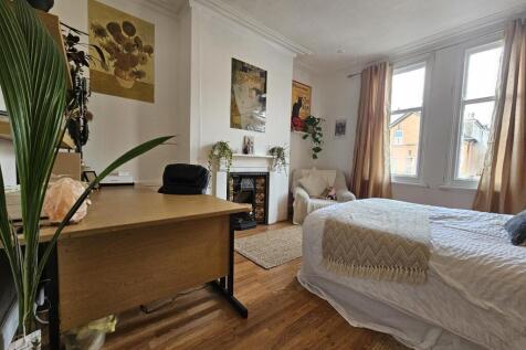 Bright and welcoming living room with ample nat...