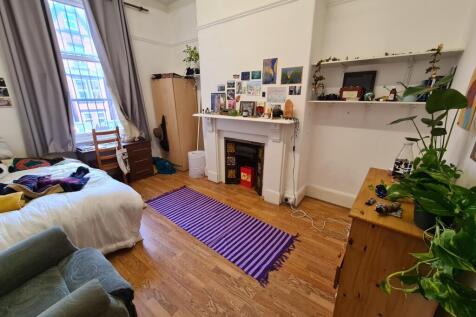 A cozy and well-lit living room with natural li...