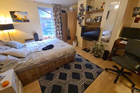 A spacious and well-lit master bedroom featurin...