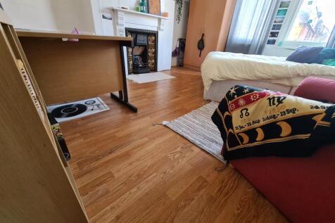 A cozy living room featuring a comfortable sofa...