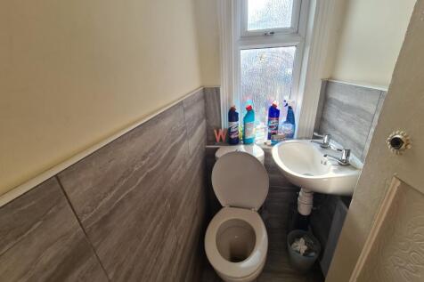 A clean and functional bathroom with a toilet, ...