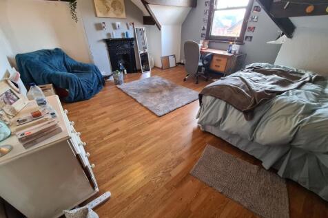 A cozy and well-maintained bedroom featuring a ...