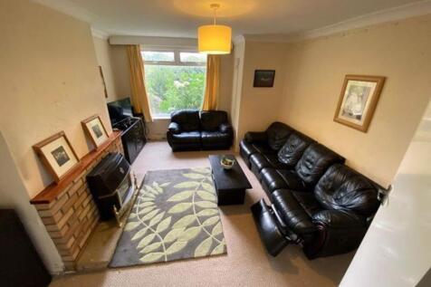 A spacious and inviting living room with a larg...