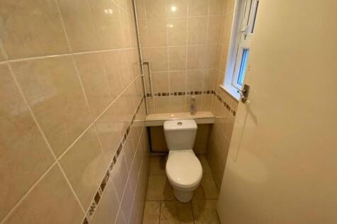 A well-maintained bathroom featuring a toilet w...