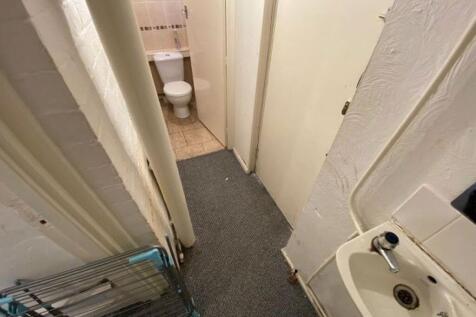 A small, functional bathroom with a sink and vi...