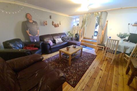 A spacious and well-maintained living room with...