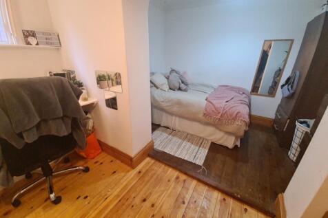 A cozy bedroom featuring a double bed with plus...