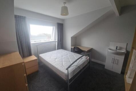 A bright and modern bedroom featuring a comfort...