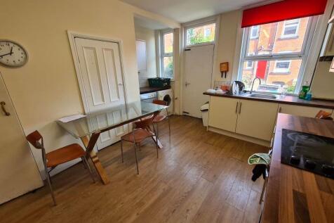 A spacious and well-lit living room featuring l...