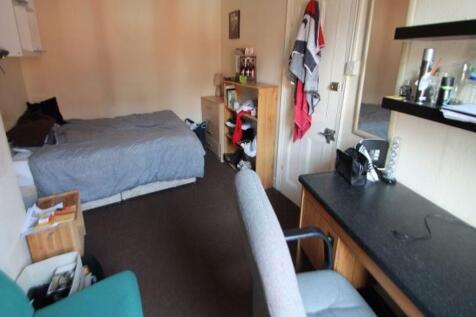 A cozy living room featuring a comfortable sofa...