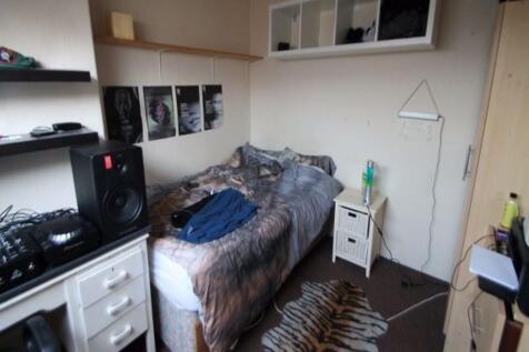 A compact, well-kept single bedroom featuring a...
