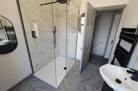 A modern, clean bathroom featuring a spacious s...