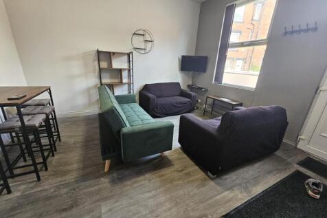 A modern and inviting living room with ample se...