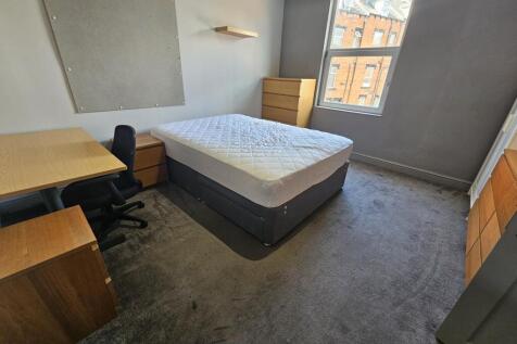 A spacious and well-lit double bedroom featurin...