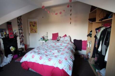 A spacious and well-lit master bedroom featurin...