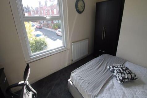 A bright and cozy bedroom with a large window p...