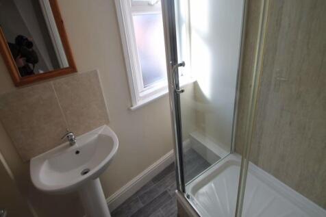 A clean and modern bathroom featuring a shower ...