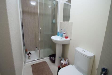 A clean and functional bathroom featuring a sho...