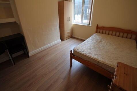 A spacious bedroom featuring a comfortable doub...