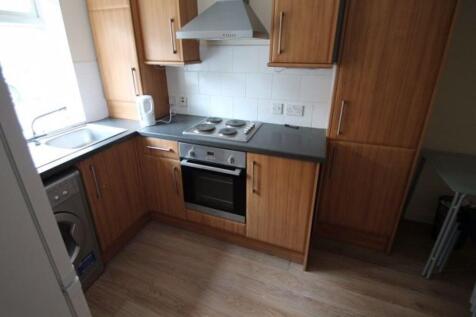 A well-maintained kitchen with wooden cabinets,...