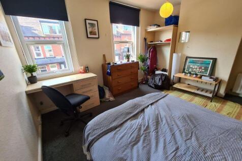 A bright and welcoming double bedroom featuring...
