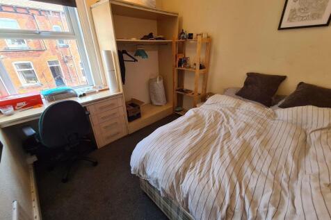 A cozy bedroom featuring a neatly made double b...