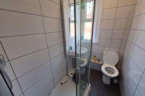 A clean and well-maintained bathroom with a sho...
