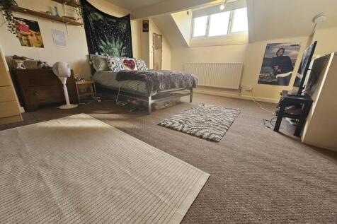 Bright and spacious master bedroom featuring a ...