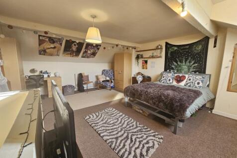 A spacious master bedroom featuring a large dou...