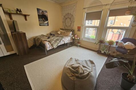 Bright and spacious bedroom featuring a comfort...